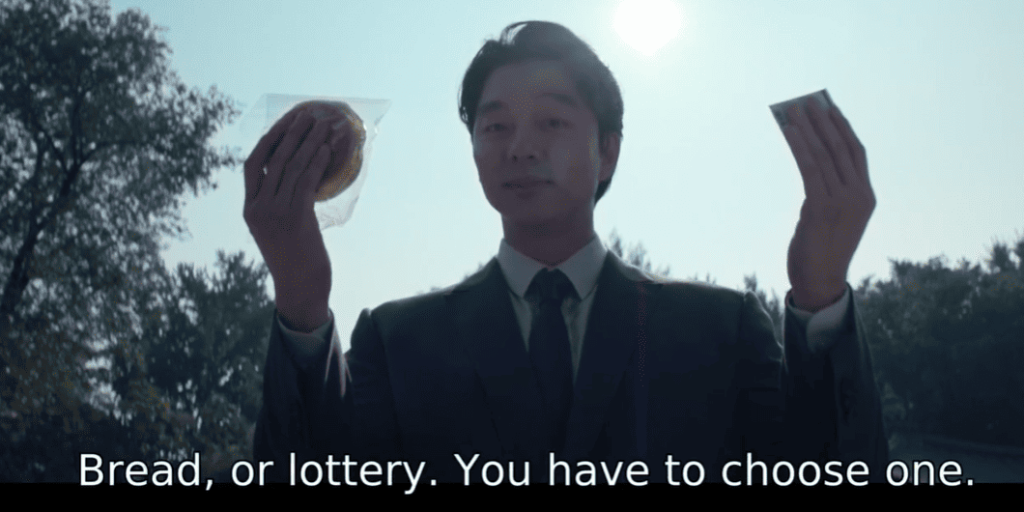 Squid Game 2: a person in a suit and tie holding up a piece of bread and a scratchcard