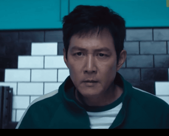 10 Must-Watch Dark Dramas: A person in a green jacket standing in front of a brick wall