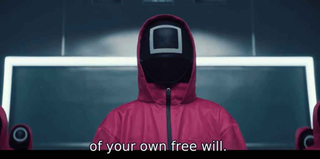 Squid Game 2: a person wearing a pink hoodie with the words of your own free will