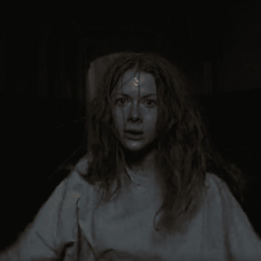 Mind-Bending Plot Twists - A person with long red hair standing in a dark hallway