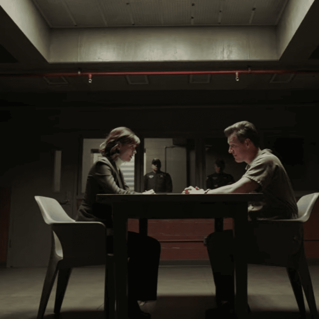 Mind-Bending Plot Twists - A person and another person sitting at a table in an empty room