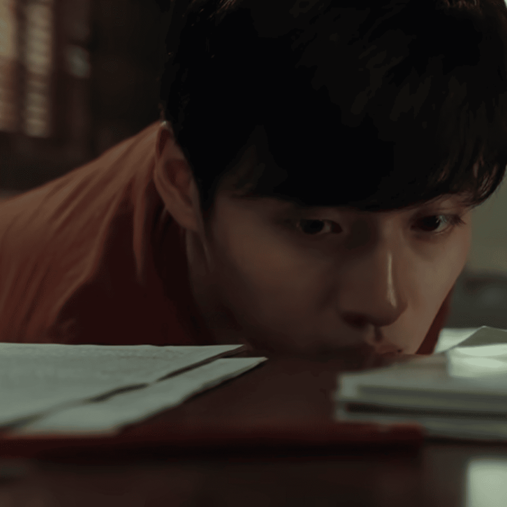 8 Mind-Bending Plot Twists - A person in an orange shirt is leaning over a desk