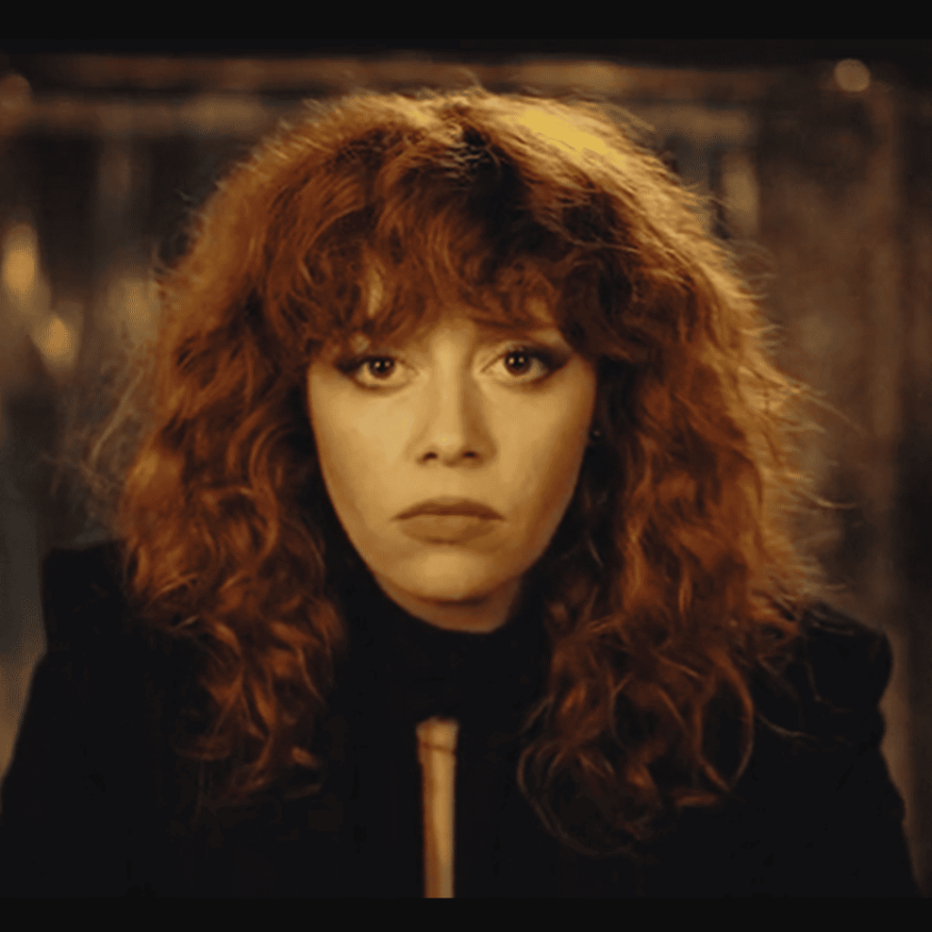 Mind-Bending Plot Twists - a person with red hair and a black jacket