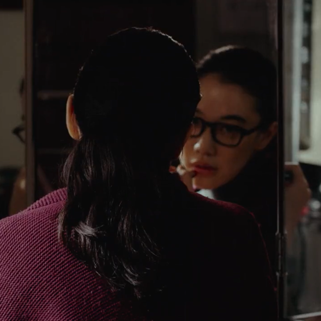 Asura Episode 1 - a person in glasses looking at themselves in the mirror