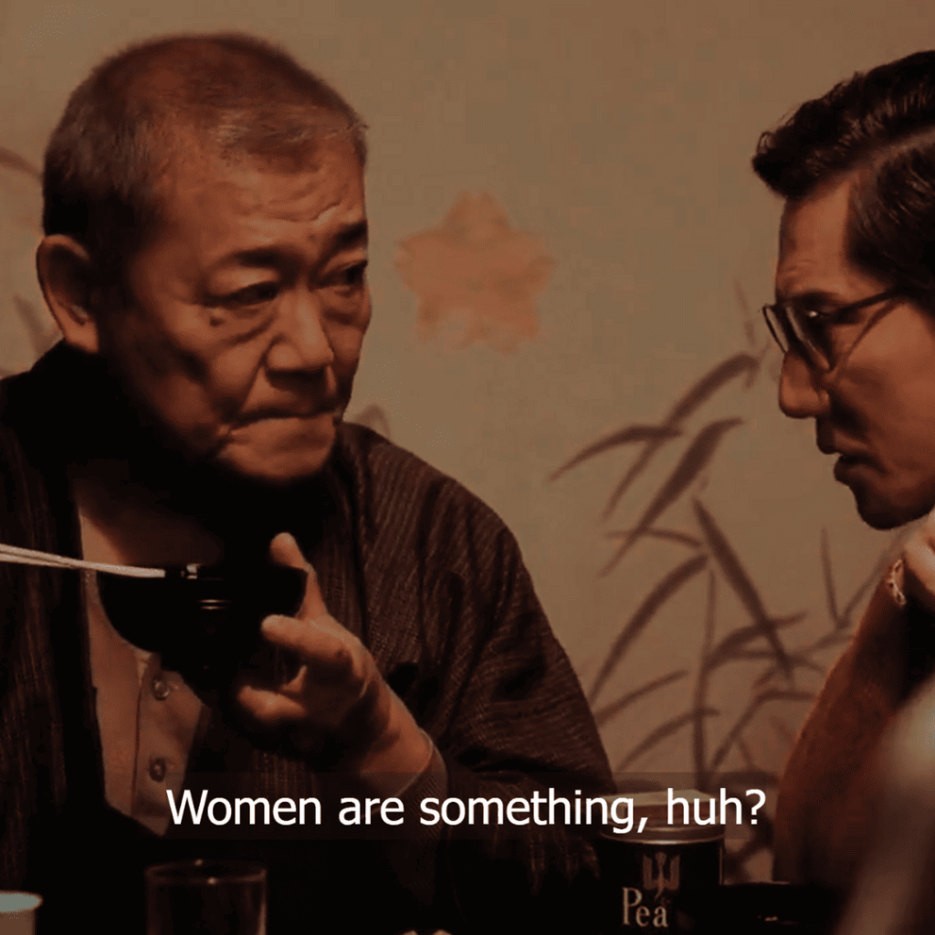 Asura Episode 1 - Two individuals sitting at a table with chopsticks in their hands