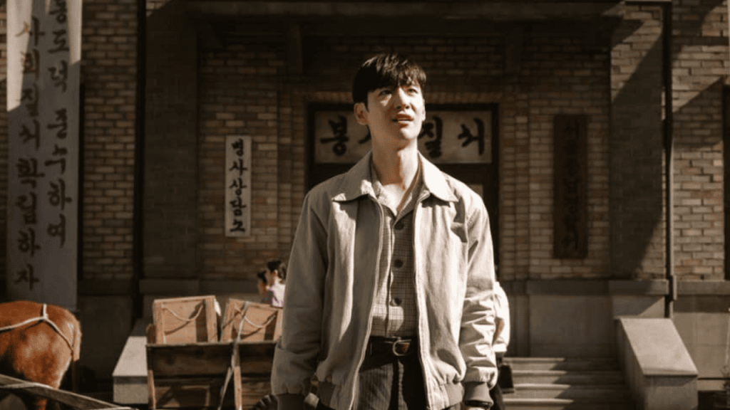 Best Korean Drama of 2024 -Chief Detective 1958 - Lee Je-Hoon standing in front of a building