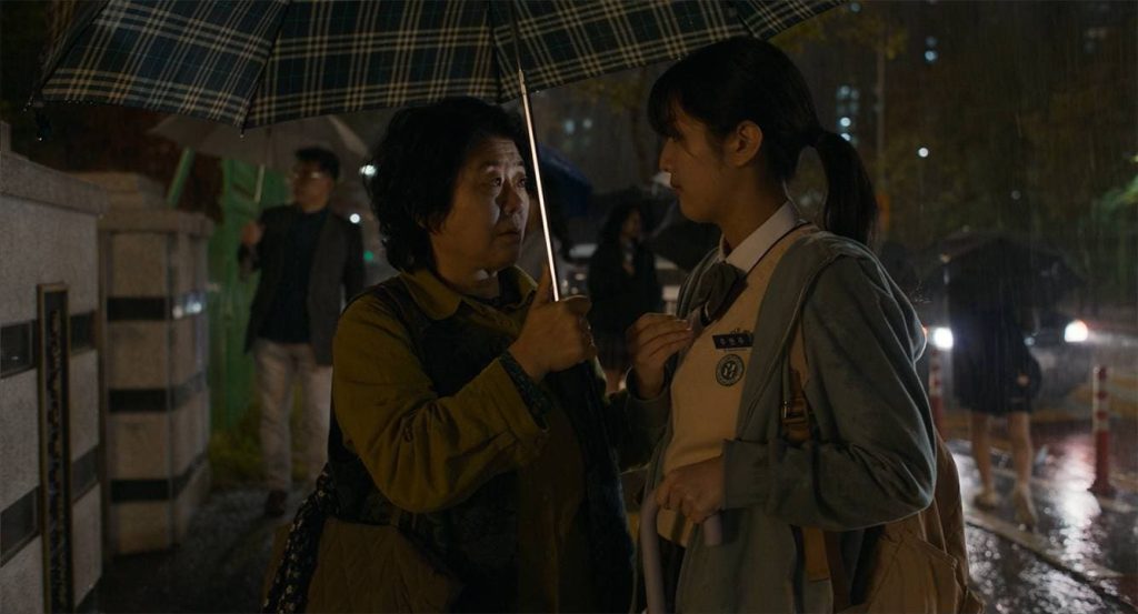 Light Shop K-Drama: two people talking under an umbrella in the rain