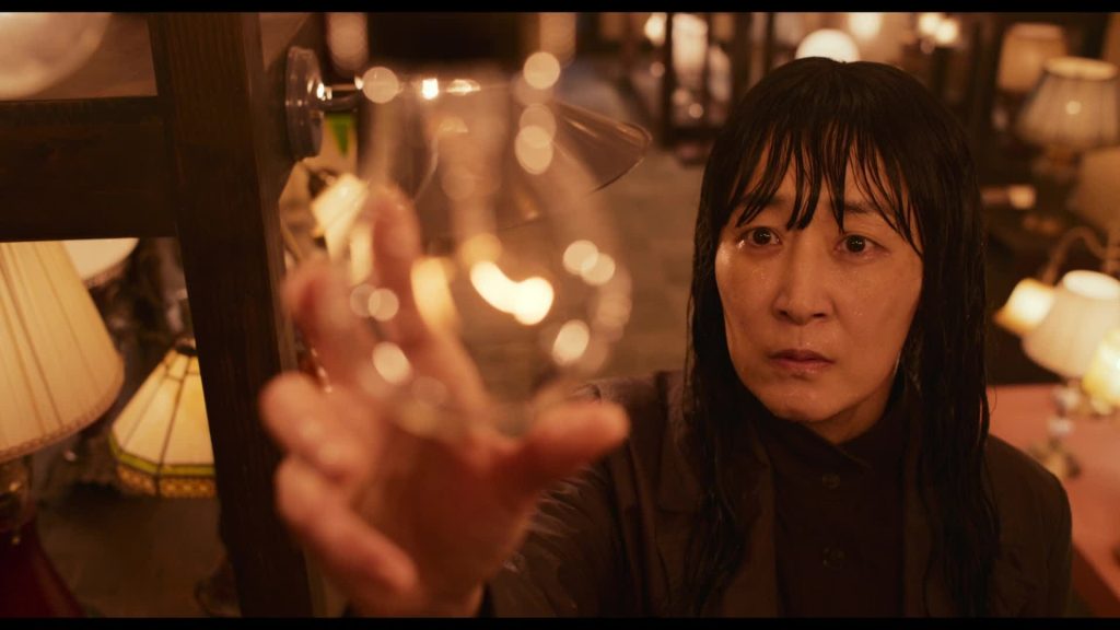 Top Korean Dramas of 2024 - Light Shop - Still of Park Hye Won holding a light in their hand