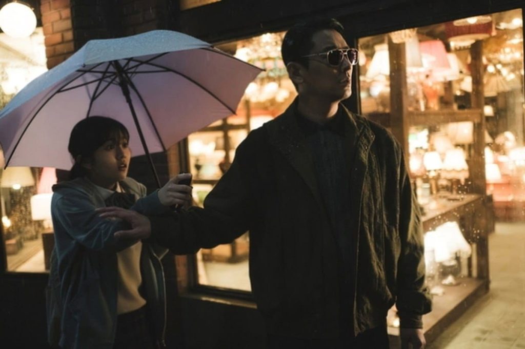 Light Shop K- Drama Two people holding an umbrella in front of a store
