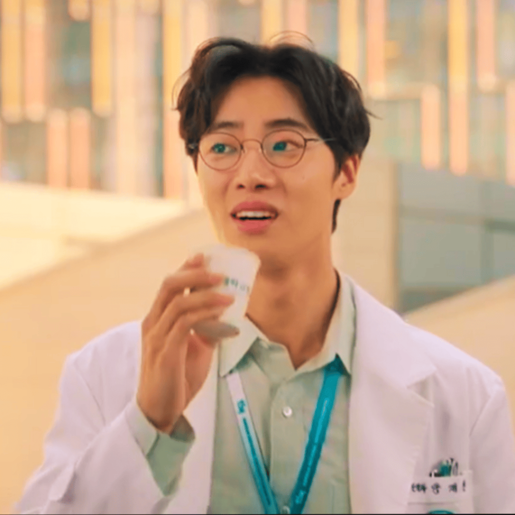 Trauma Code: A person in a white lab coat holding a cup