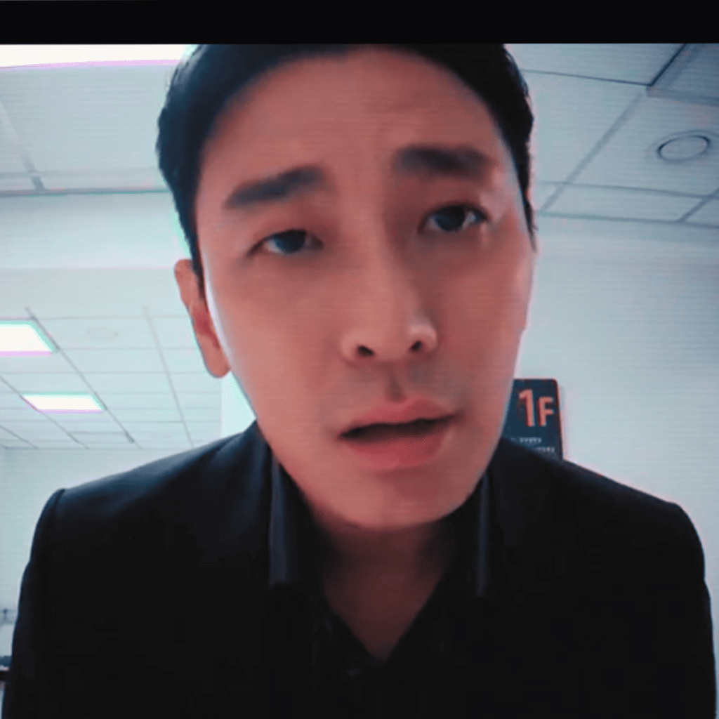 Trauma Code: A person in a suit is looking at the camera