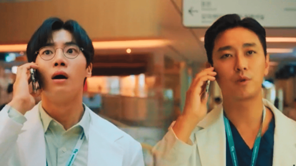 Trauma Code: two individuals in white lab coats talking on their cell phones
