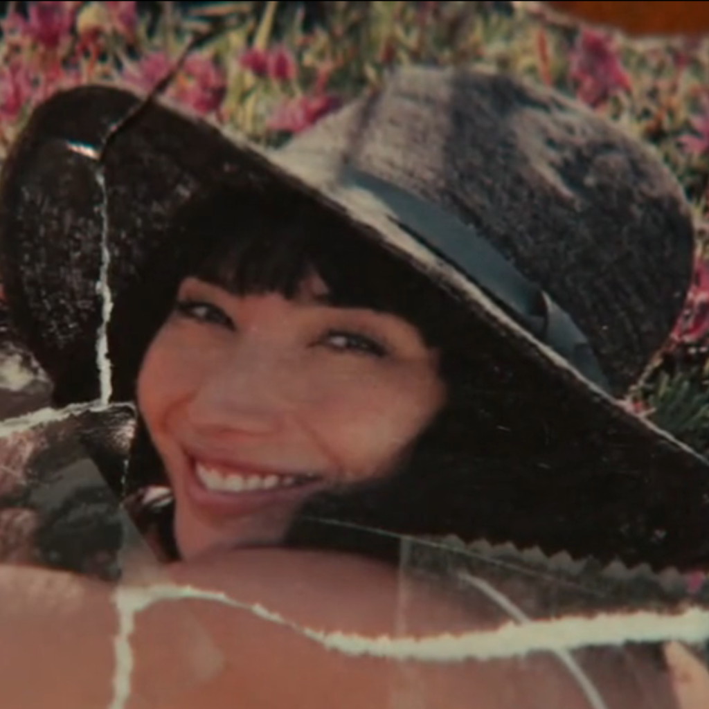 Severance Season 1 Ending Explained: a person wearing a hat and smiling in front of flowers