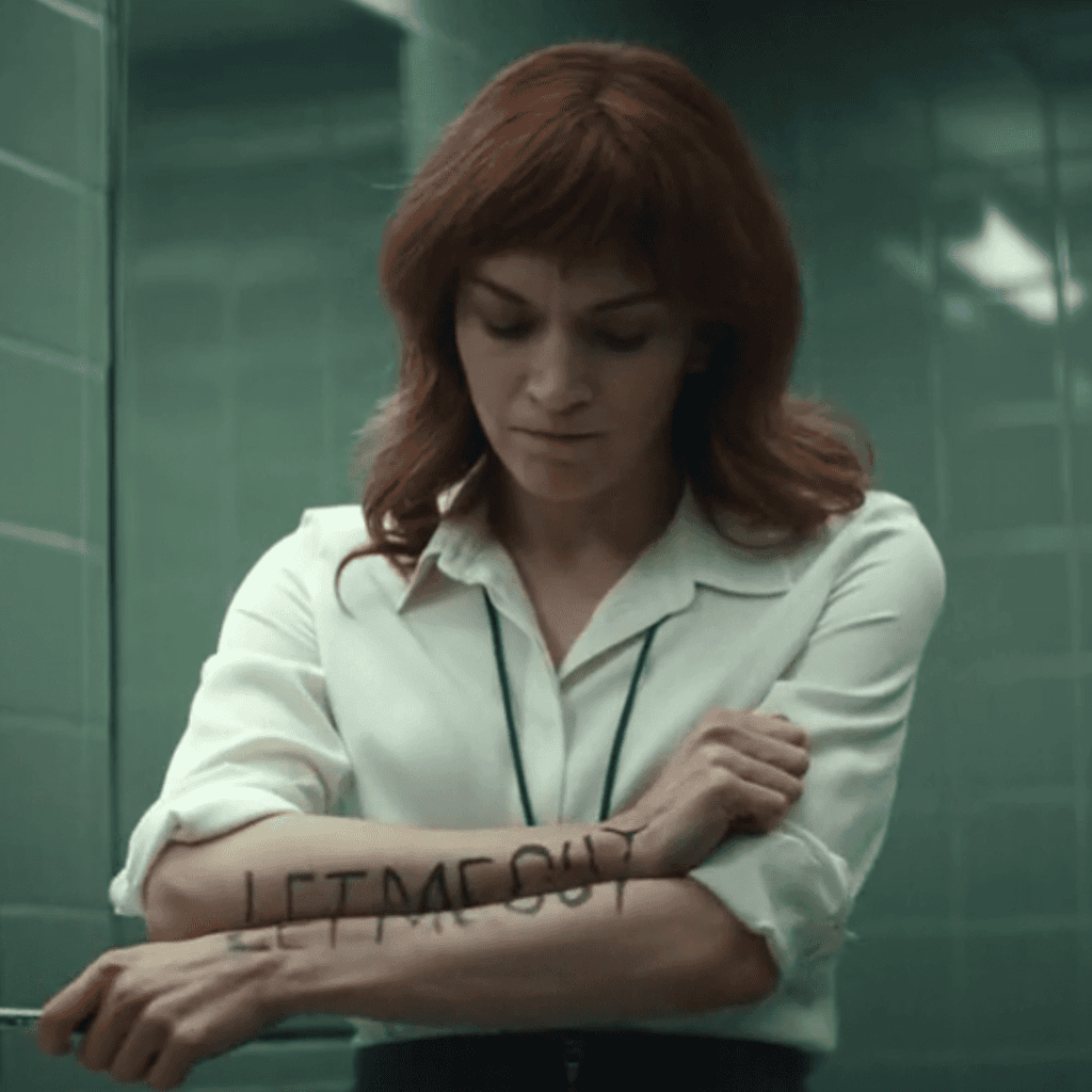 Severance Season 1 Review: A person in a white shirt is standing in front of a mirror.