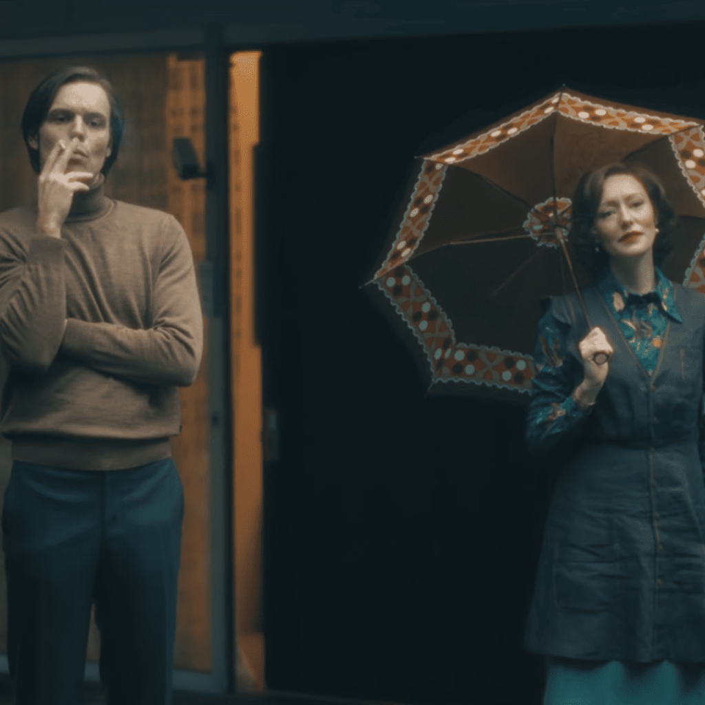 Cassandra Netflix Review: A person and another person standing next to each other with umbrellas.