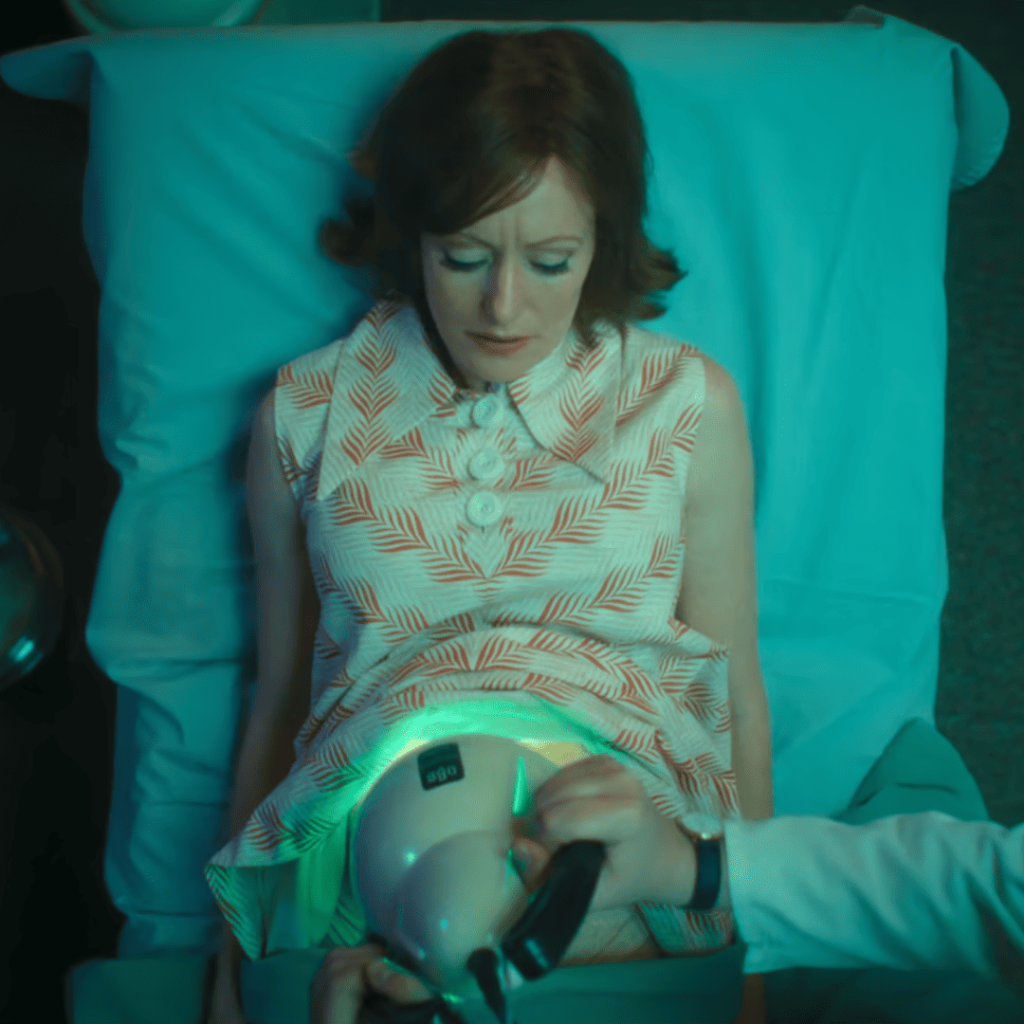 Cassandra Netflix Review: A person laying in a hospital bed with a green light on their stomach.