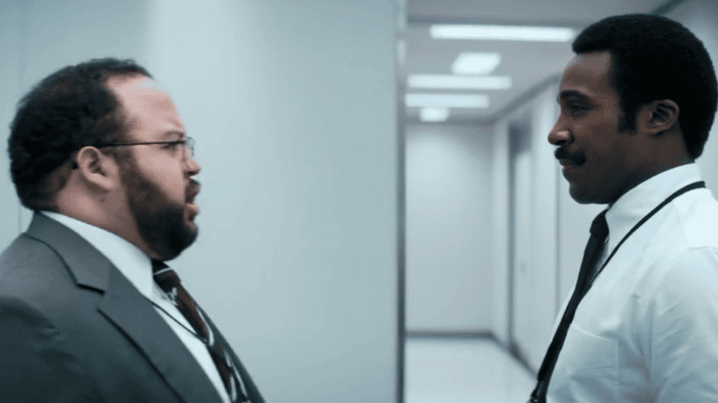 Severance Season 1 Review: two individuals in suits talking to each other in an office