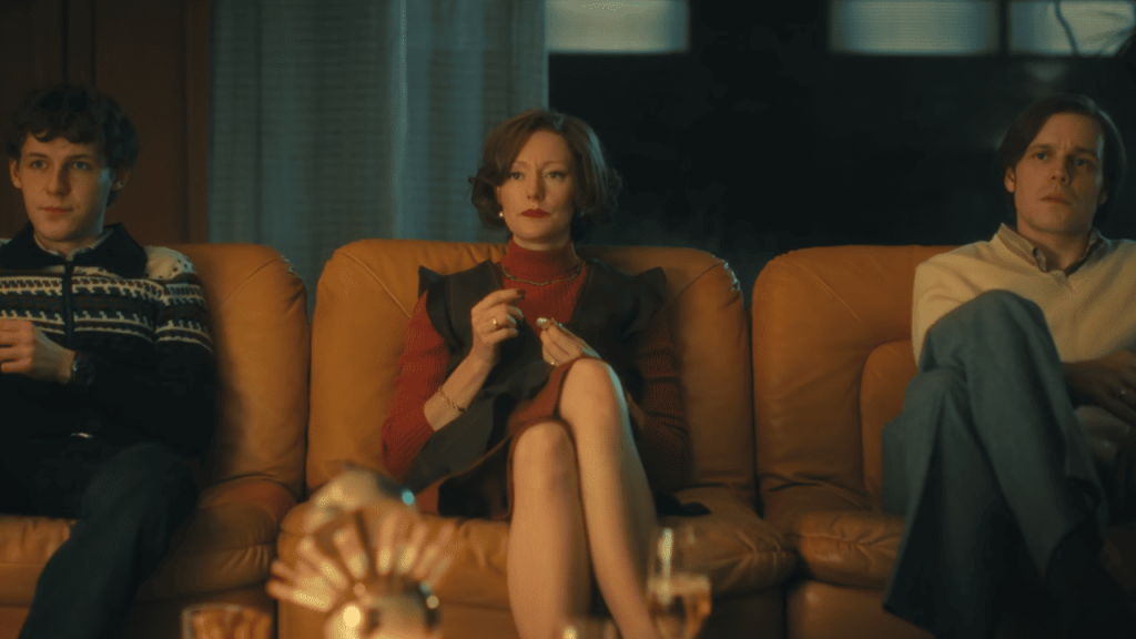 Cassandra Netflix Review: A group sitting on a couch.