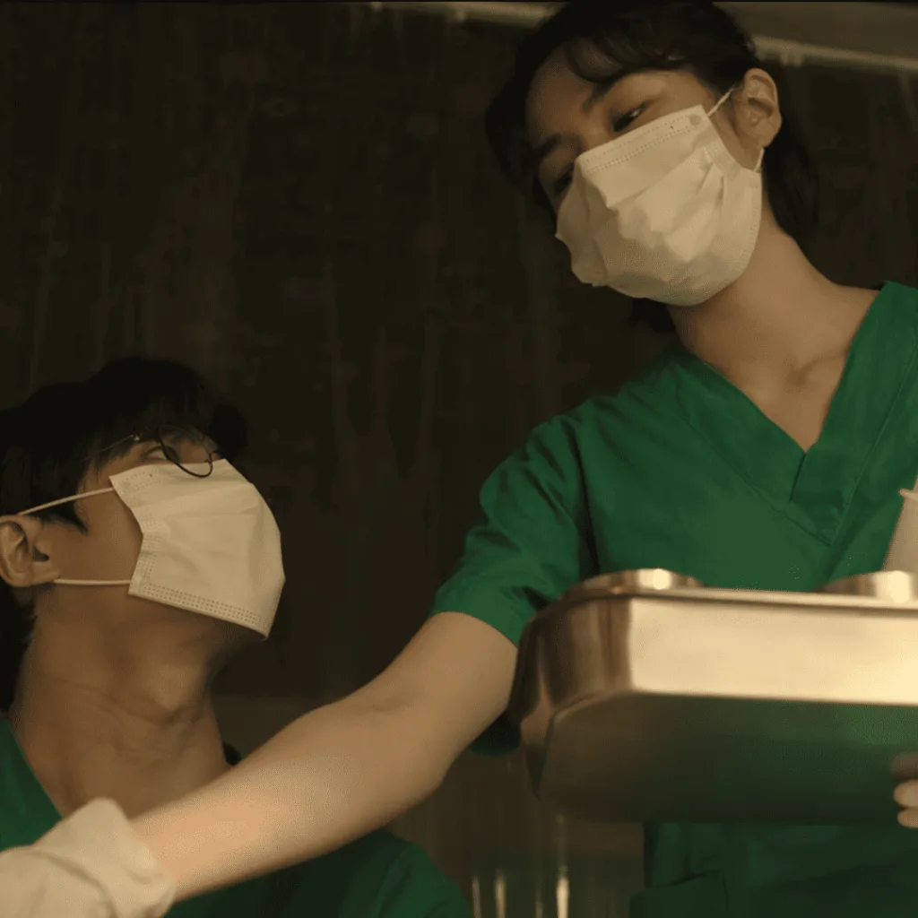 Trauma Code Review: A man and woman in scrub suits holding a tray