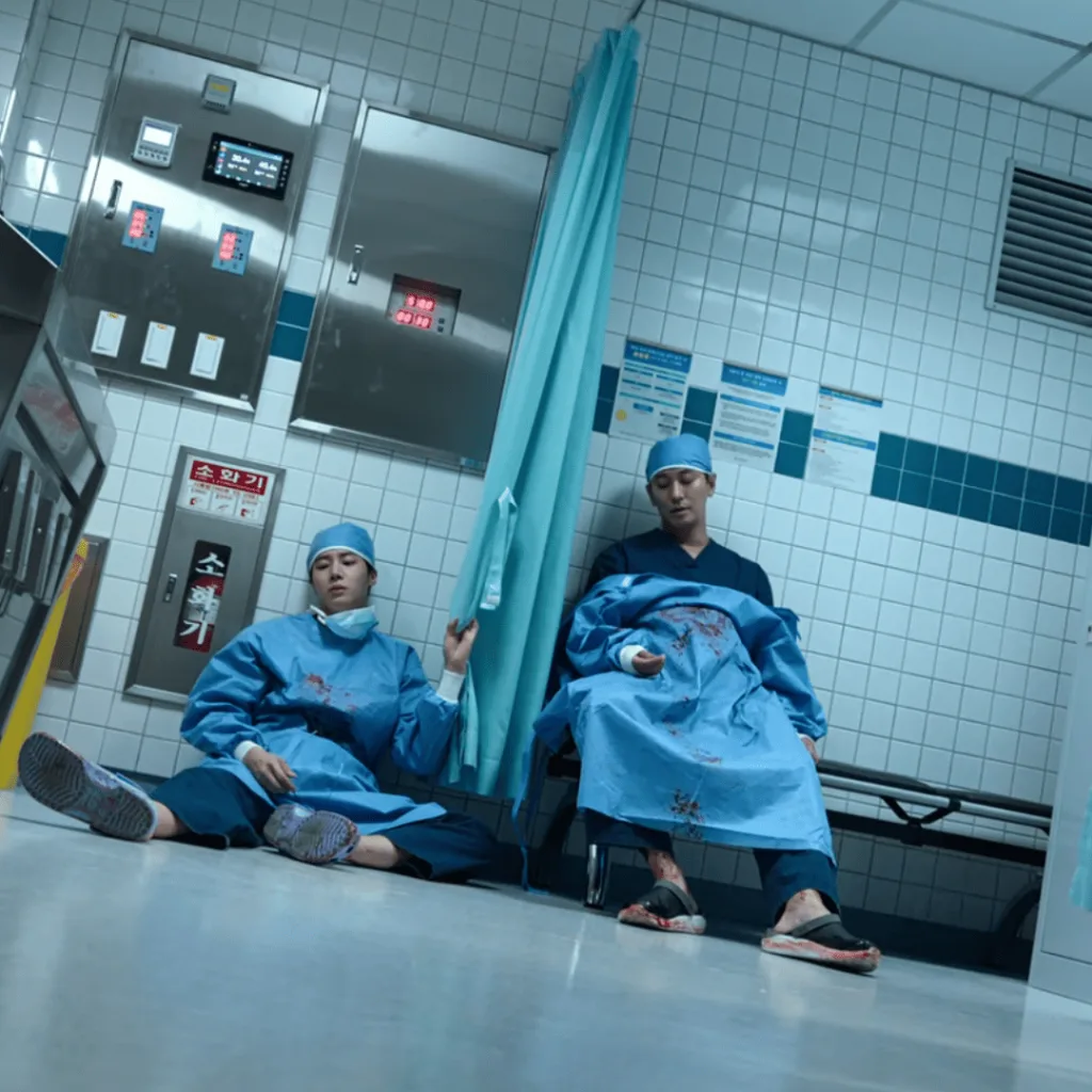 Trauma Code Review: two people sitting on the floor in an operating room
