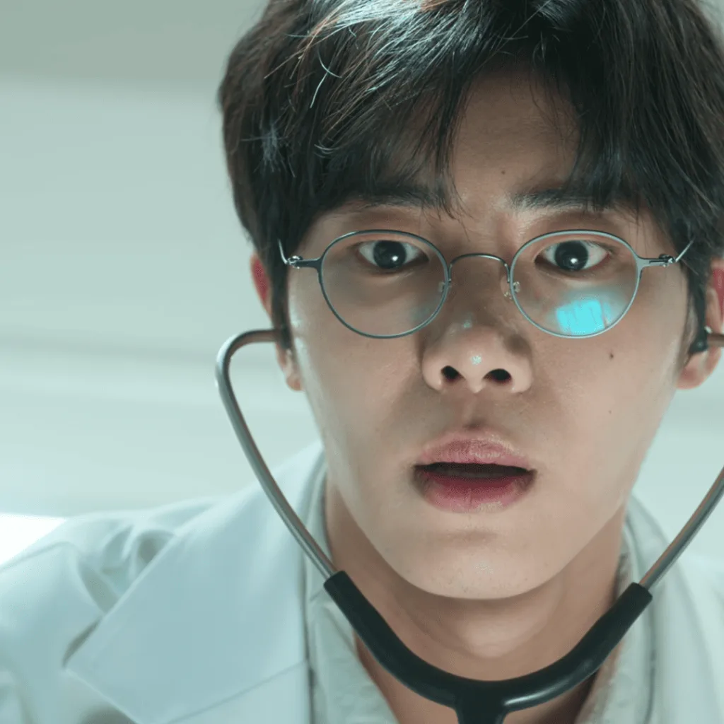 Trauma Code Review: A person with glasses and a stethoscope