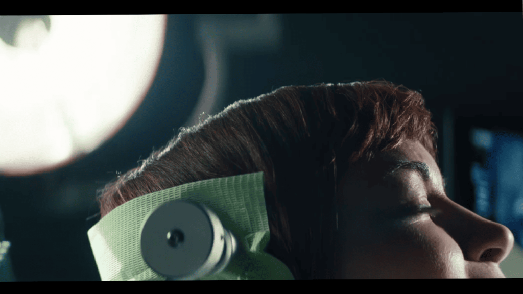 Severance Season 1 Ending Explained: a person with a clamp on their head in an operating room