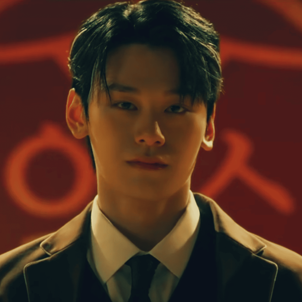 Study Group K-Drama Review: a person in a suit and tie standing in front of a red background