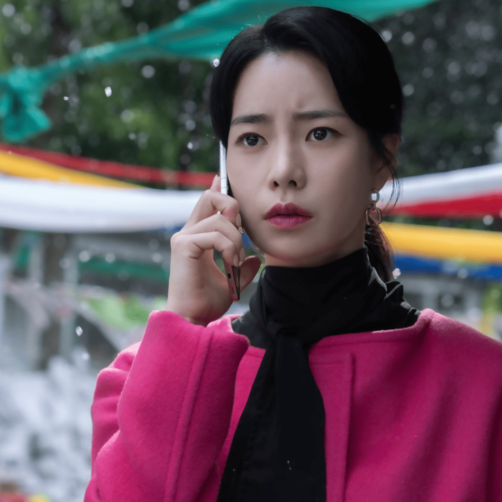 revenge k-dramas: A person in a pink coat talking on a cell phone.