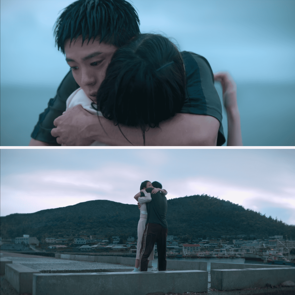When Life Gives You Tangerines Review: A couple standing on top of a wall near a body of water.