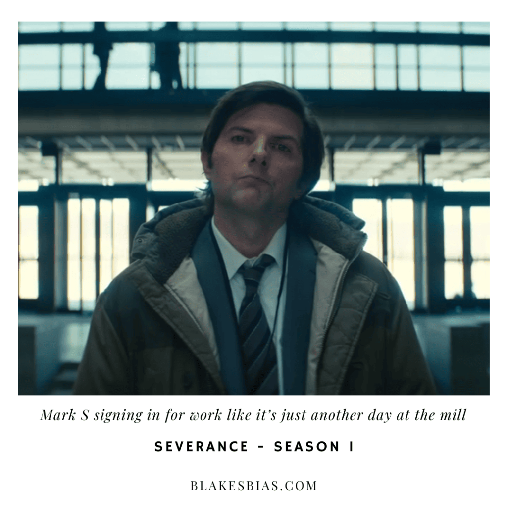 Best Severance Characters: A person in a coat and tie standing in an airport.