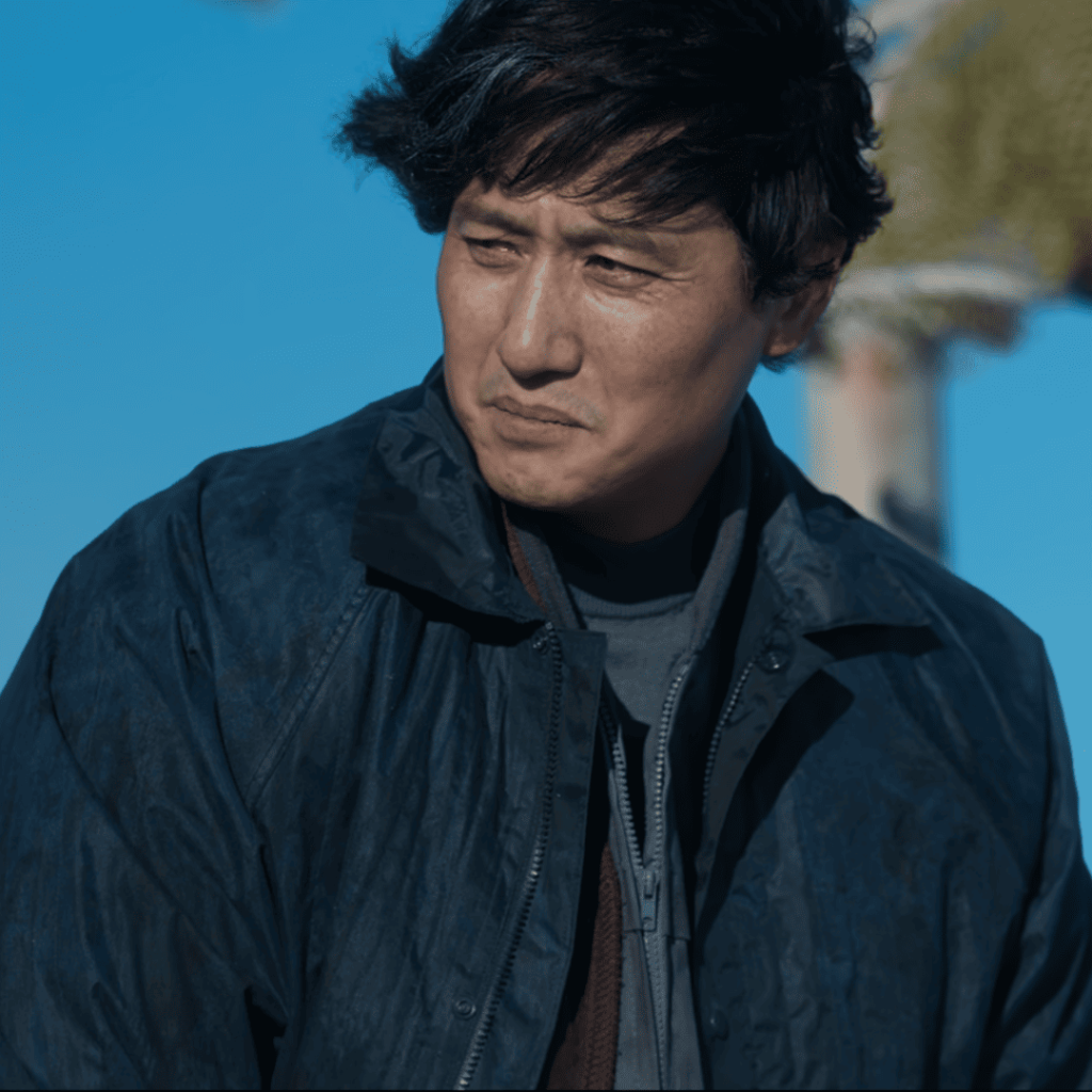 When Life Gives You Tangerines Full Review: A person in a black jacket standing on a boat