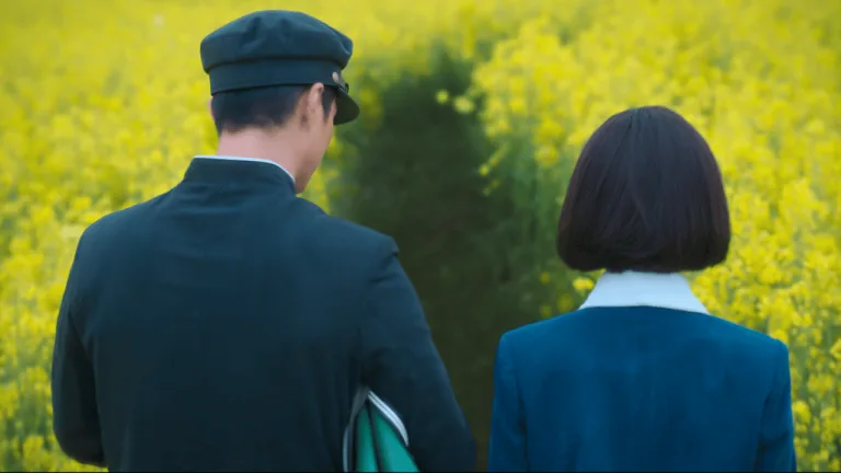 When Life Gives You Tangerines Full Review: A couple walking through a field of yellow flowers.