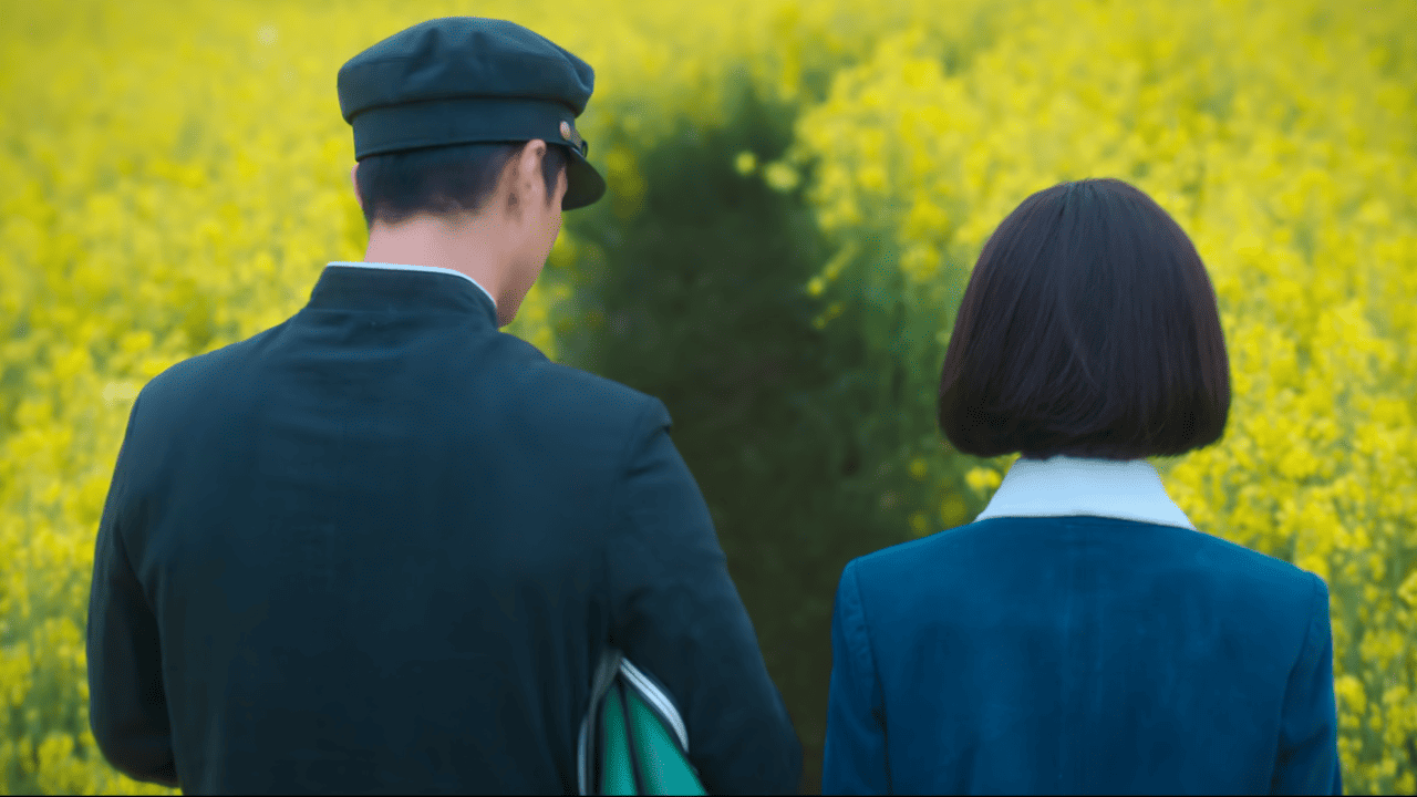 When Life Gives You Tangerines Full Review: A couple walking through a field of yellow flowers.