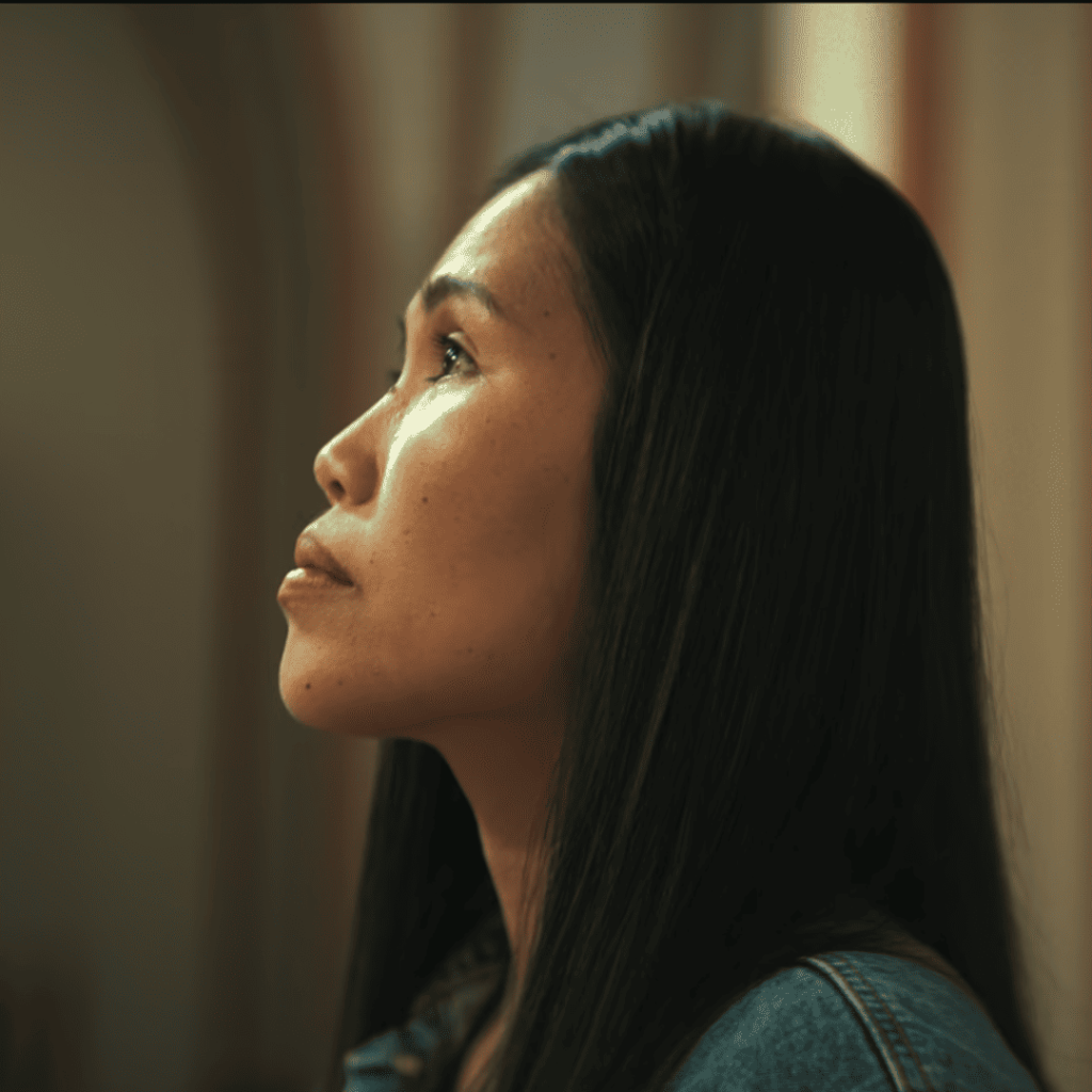 Angel kneels in prayer for Rose inside the church, visibly distraught in Secrets We Keep