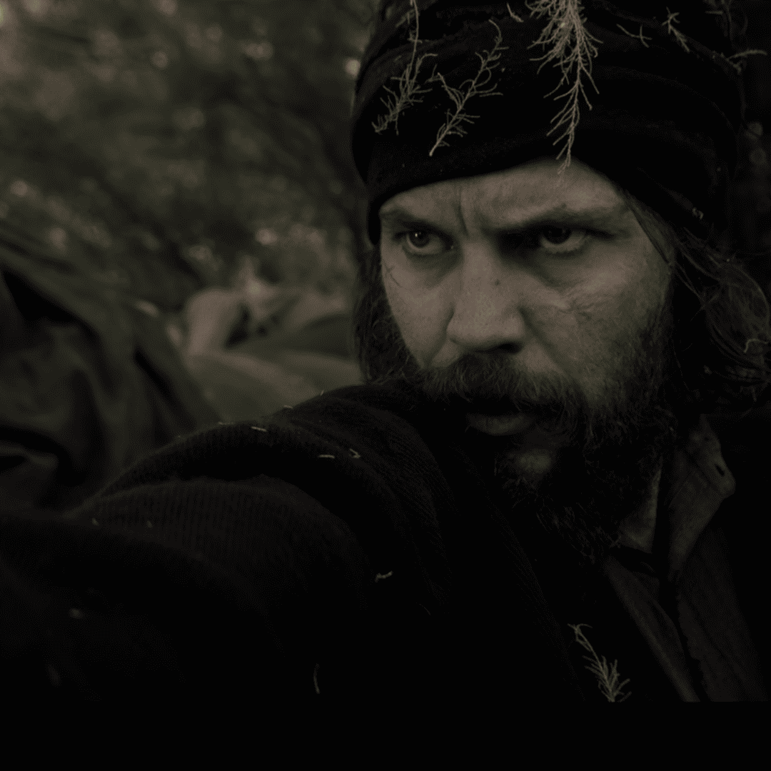 American Primeval Review: a person with a beard and turban in the woods