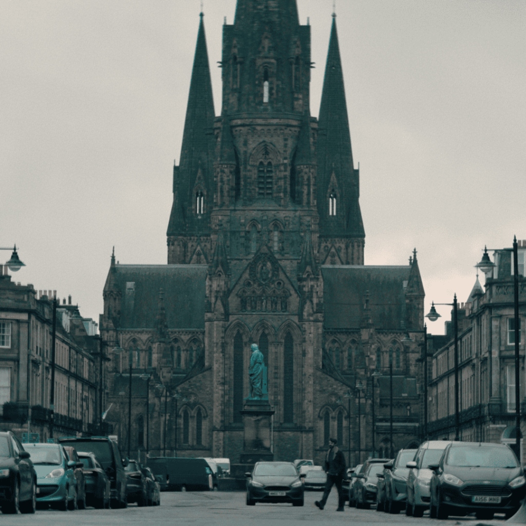 Dept Q Episode 1 Review: Carl Morck crosses the street near St Mary’s Episcopal Cathedral in Edinburgh