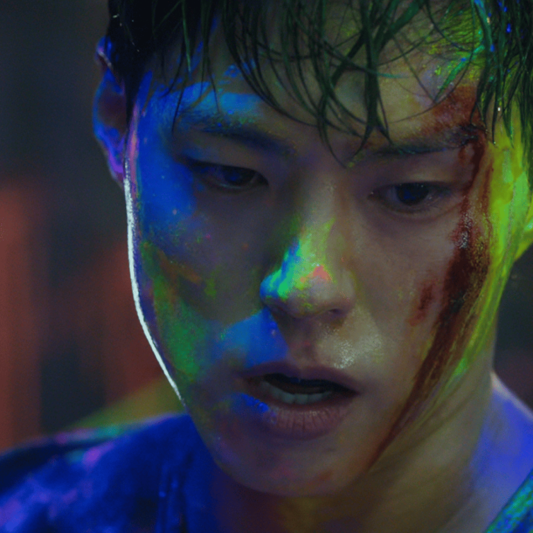 Park Bo-gum in Good Boy, bruised and defiant after the paint-splattered fight scene—capturing the chaos, brotherhood, and battered justice that defines the drama’s soul.