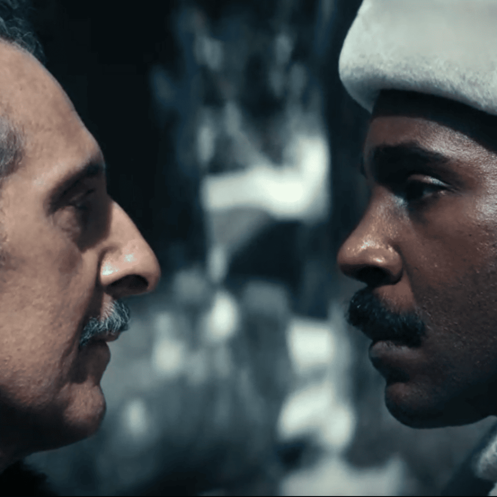 Severance Season 2 Identity: Close up of Irving and Milchick in fur hats staring each other down