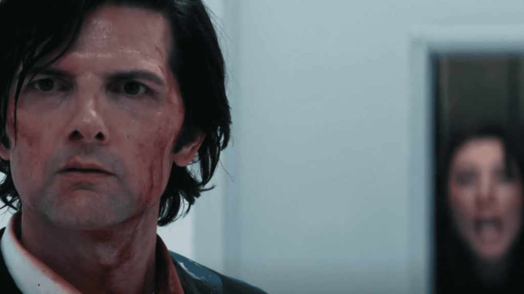 Severance Season 2 Identity: Innie Mark, bloodied and exhausted stands with his back to Gemma