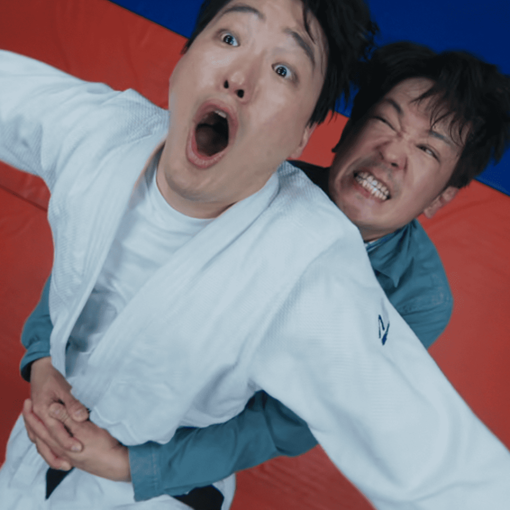 Good Boy Kdrama First Impressions: Two men mid-wrestle on a red mat, one with a shocked expression