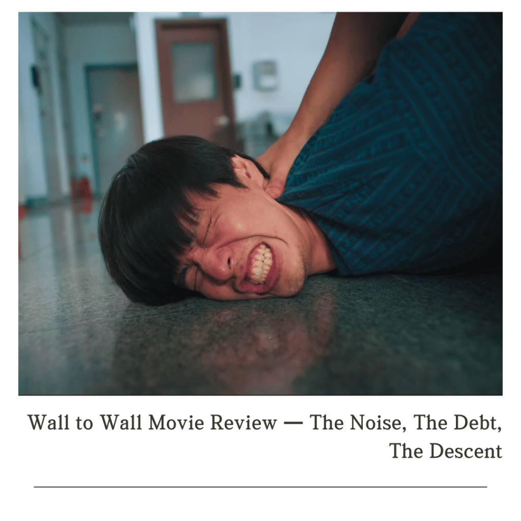 Wall to Wall Movie Review: Man pinned to the ground in distress, capturing the tension in Wall to Wall