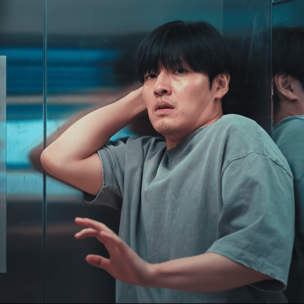 Woo Seong recoils in an elevator as the neighbor from 1301 reveals a craft knife in Wall to Wall Movie Review