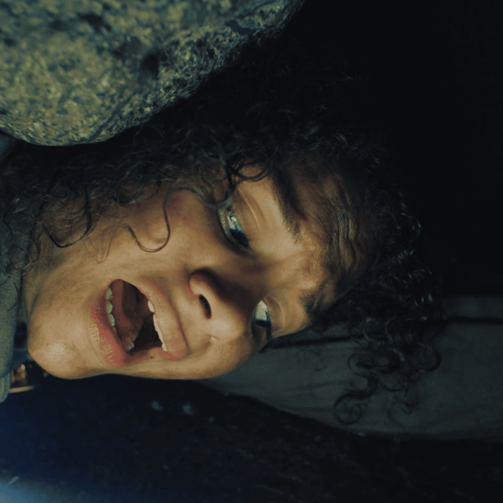 Untamed Netflix Review: Close-up of Naya Vasquez trapped in a dark underground tunnel, her face contorted in fear as water begins to flood in—capturing a raw, claustrophobic panic attack.