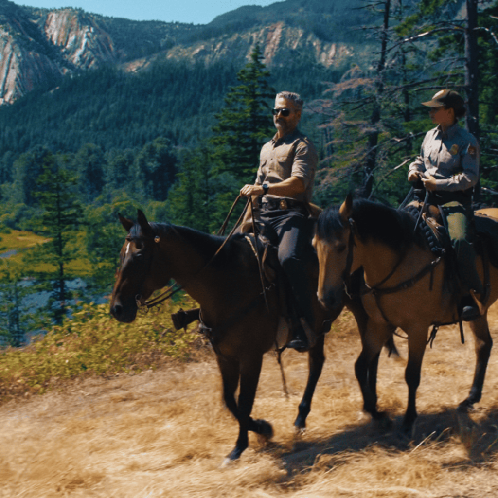 Untamed Netflix Review: Kyle and Naya riding horseback through the vast Yosemite wilderness, a moment of quiet reflection framed by towering trees and open skies.