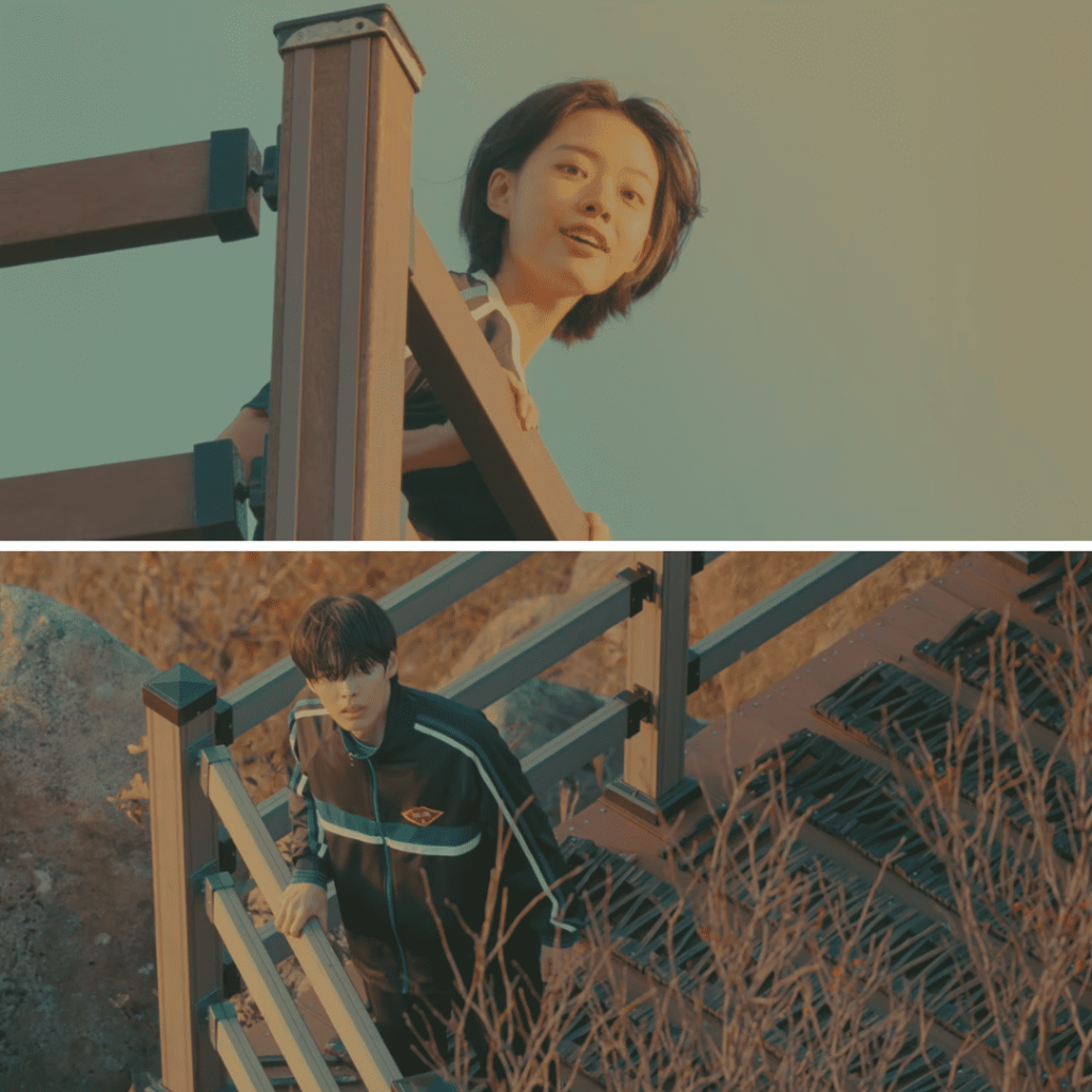 Our Unwritten Seoul Review:  Miji and Hosu stand on different levels of a wooden staircase, looking at each other with gentle curiosity, symbolizing small moments of connection.