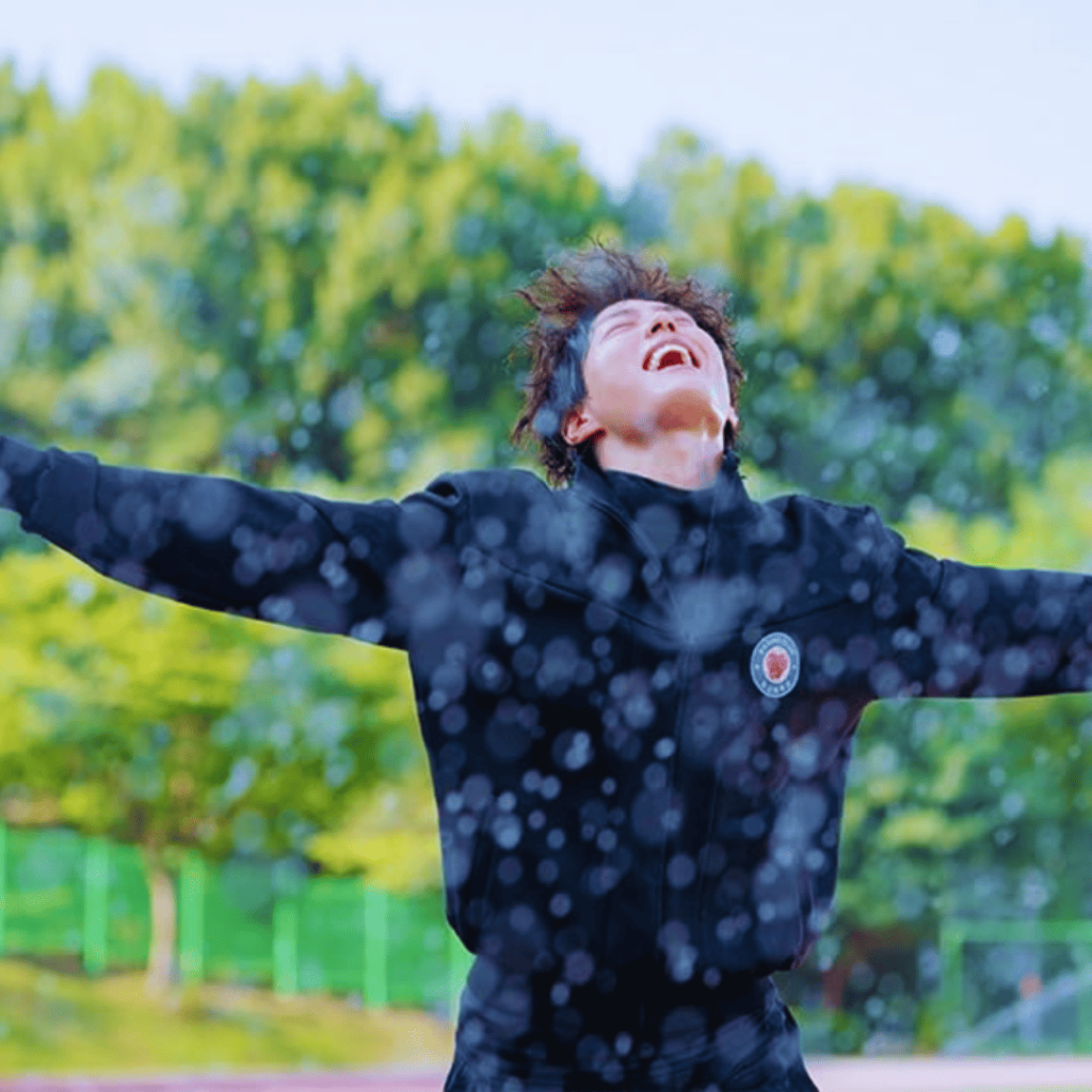 Good Boy K-drama Review: Yoon Dong-ju stands with arms outstretched, drenched under a water hose after completing 100 punishing laps.