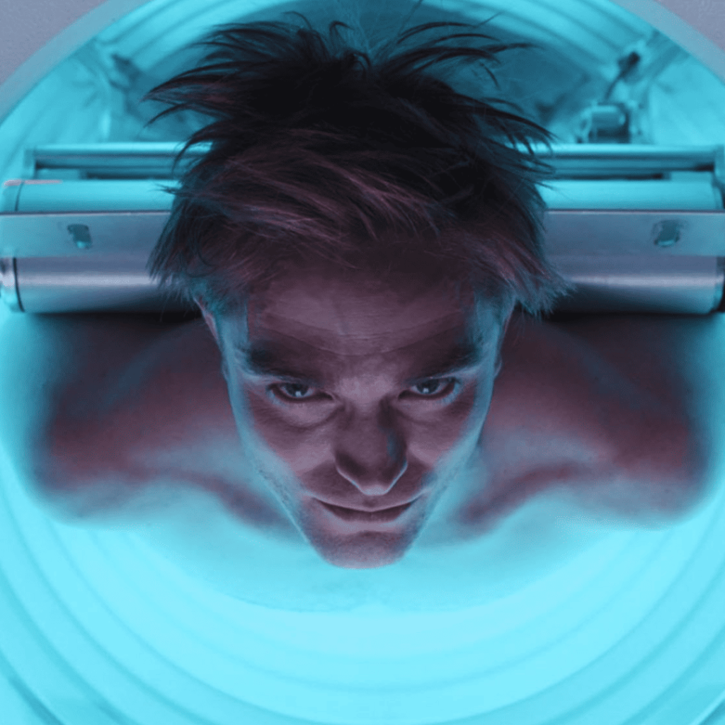 Robert Pattinson emerging freshly printed as a clone in Mickey 17.