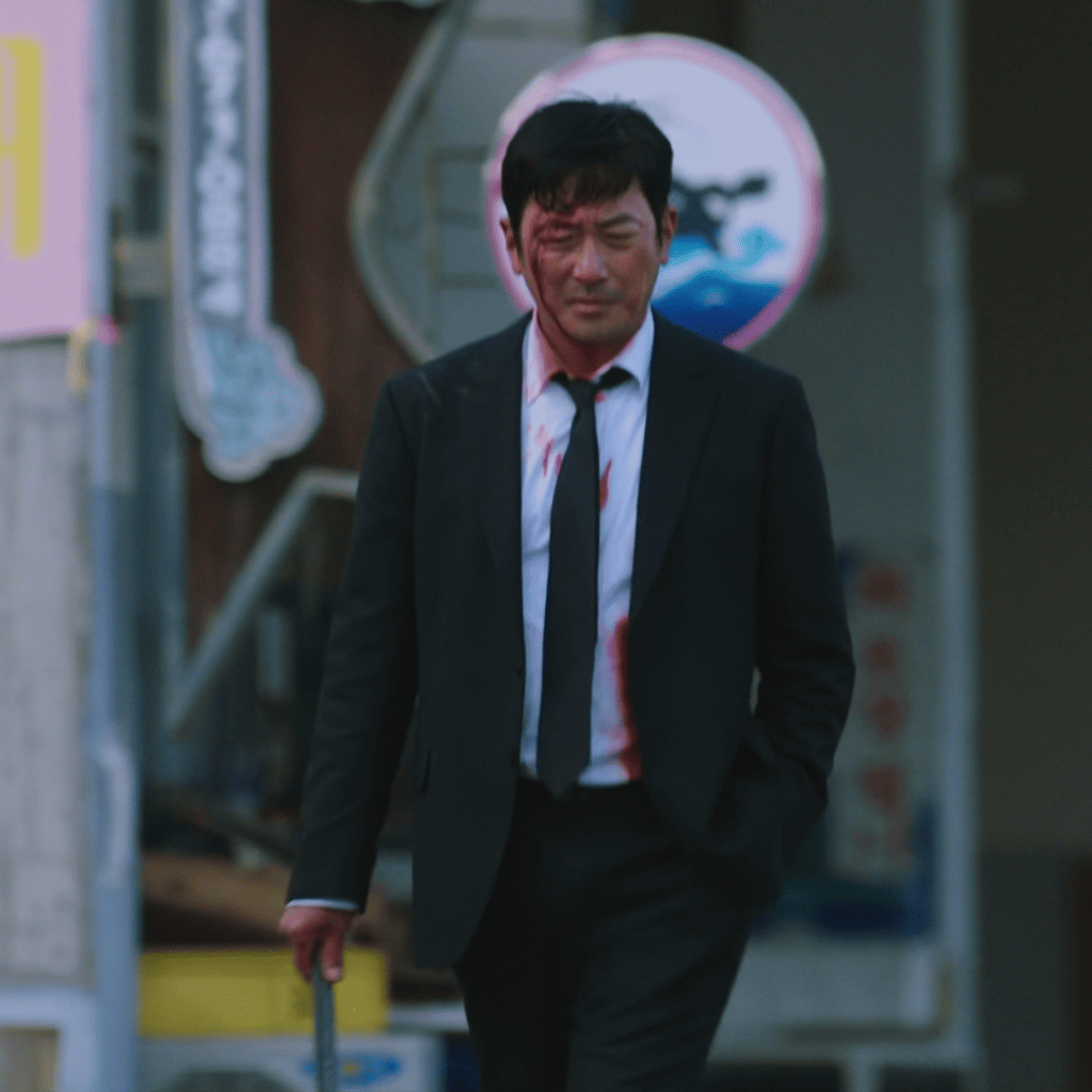 Nocturnal Movie Review finale scene of Ha Jung-woo in a bloodied suit holding his infamous metal bar after avenging his brother.