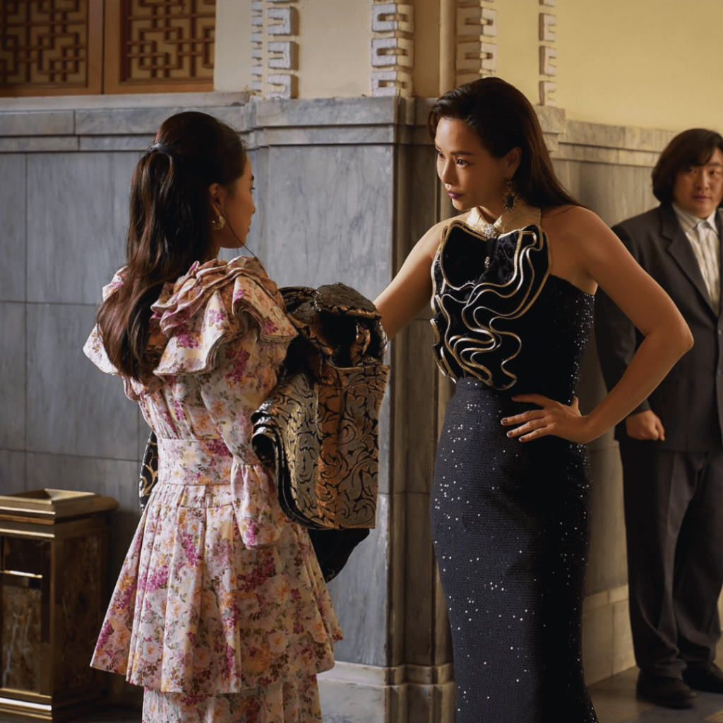 Aema Netflix Review – Hee Ra and Ju Ae facing each other in glamorous gowns, symbolizing rivalry and sisterhood.