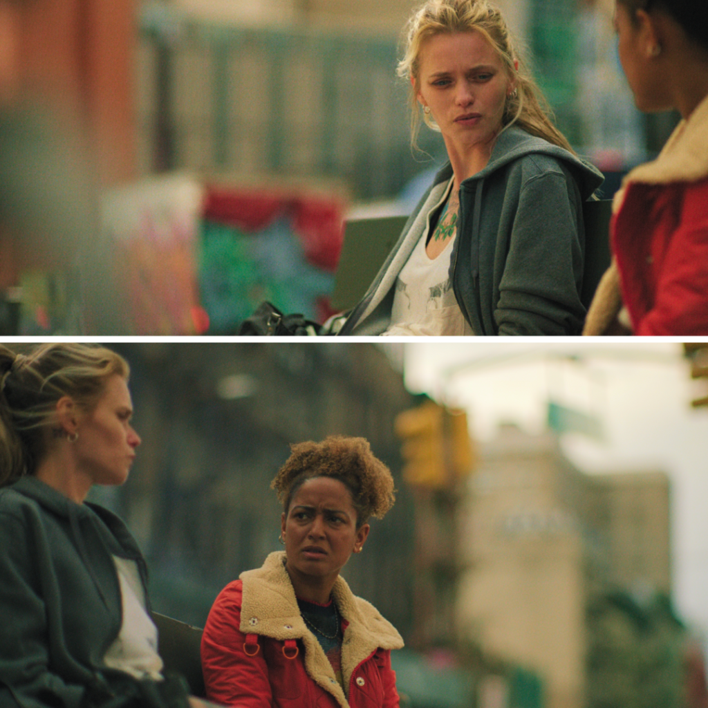 Black Rabbit Netflix Review: Anna and Roxie sitting on a bench, opening up in a heart-to-heart moment that reveals hidden truths and tough choices